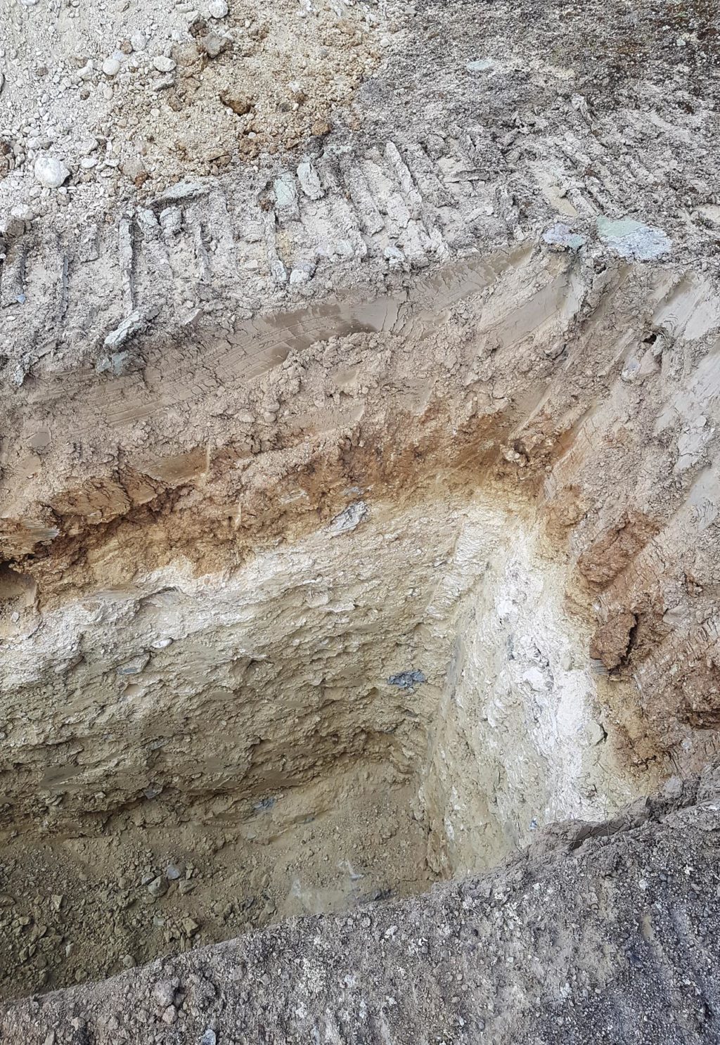 Soil pit at the Prophet's Rock Home Vineyard, showing brown clay above a pale layer of chalk