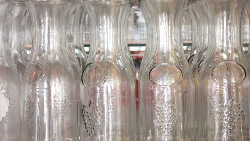 several traditional wine carafes with embossed grapes